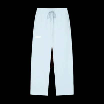 Light blue athletic pants with a white drawstring and a white 'OG' logo on the left thigh, shown against a plain white background.